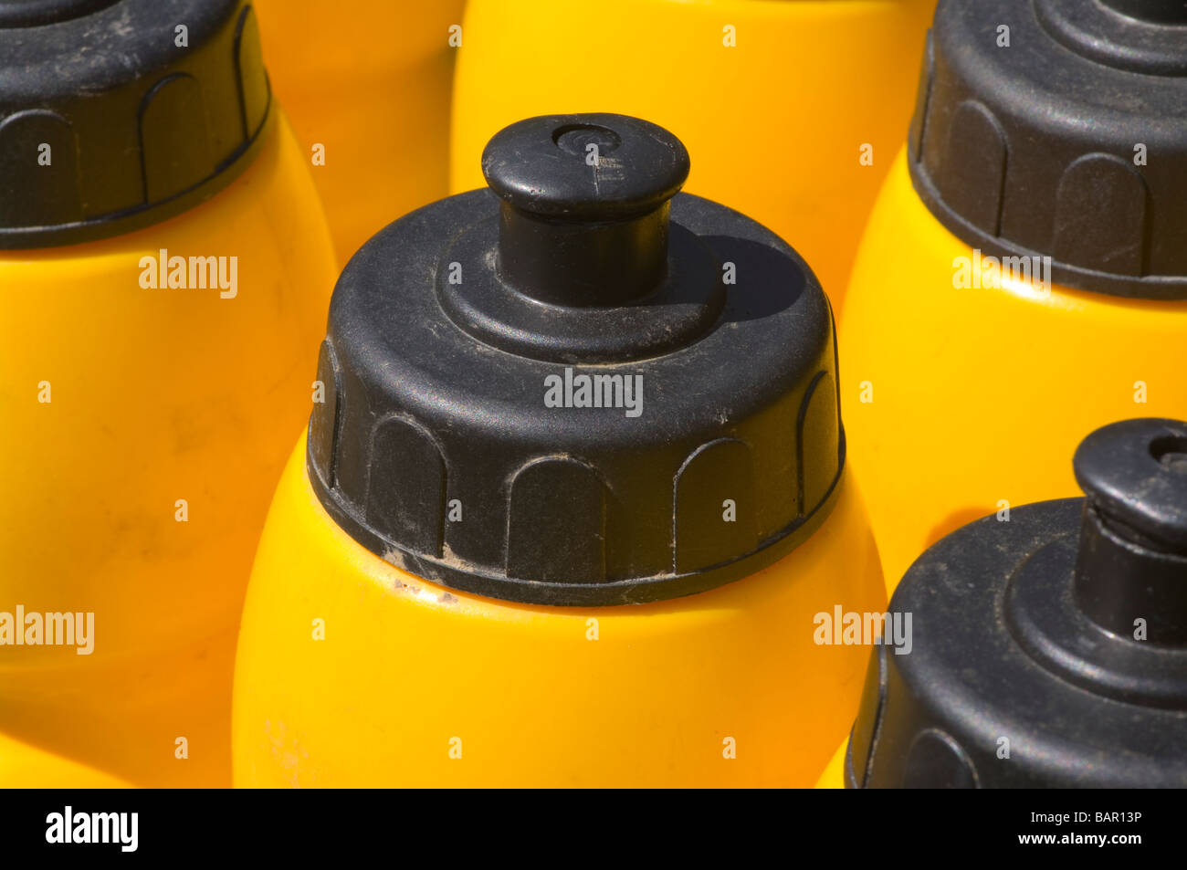 Sports Drink Plastic Drinks Bottles In a Rack For Sportsmen Stock Photo