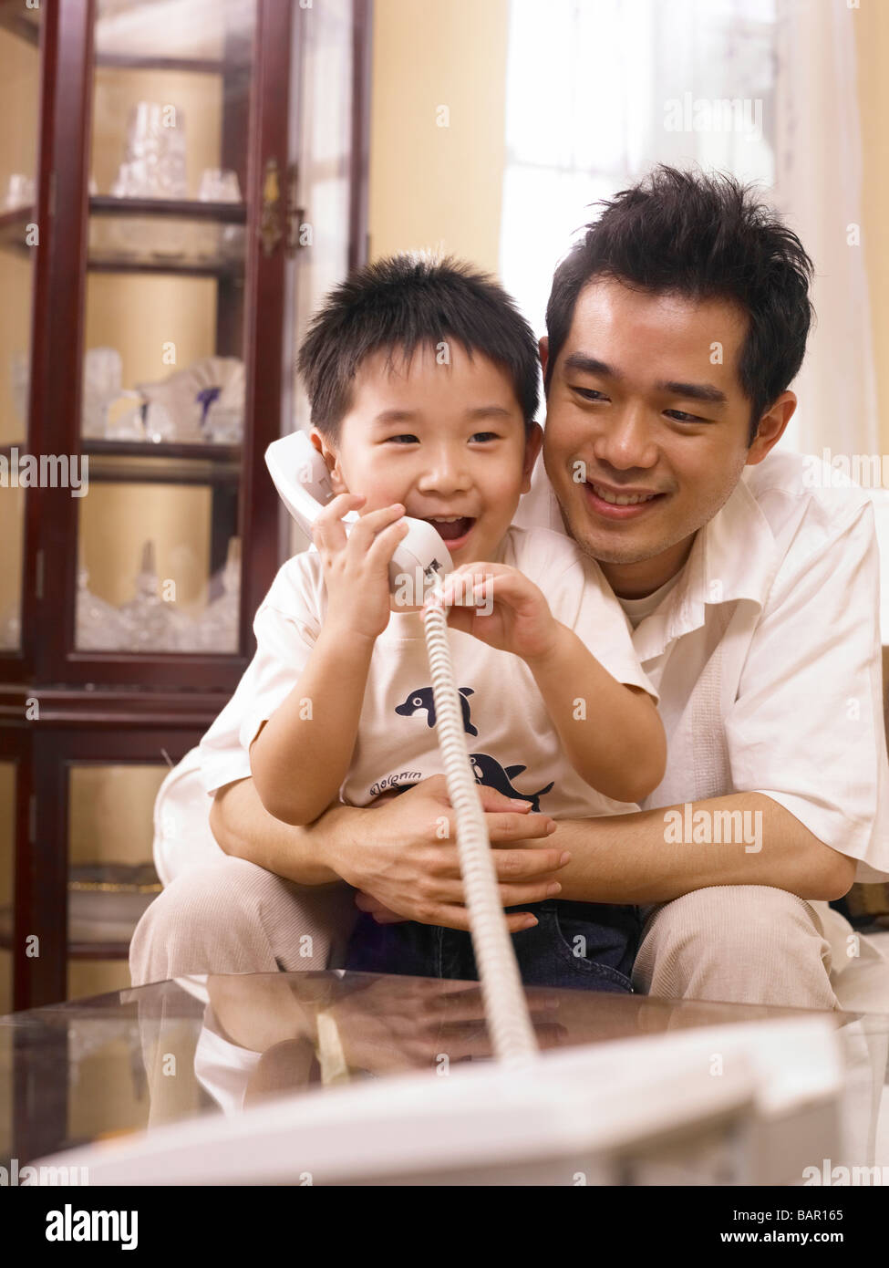 father and son making phone call together Stock Photo - Alamy