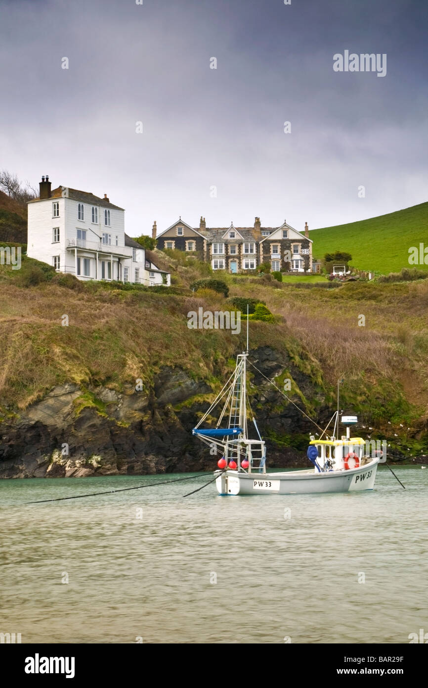 A few houses and a boat in the harbor of Port Isaac in Cornwall. Stock Photo