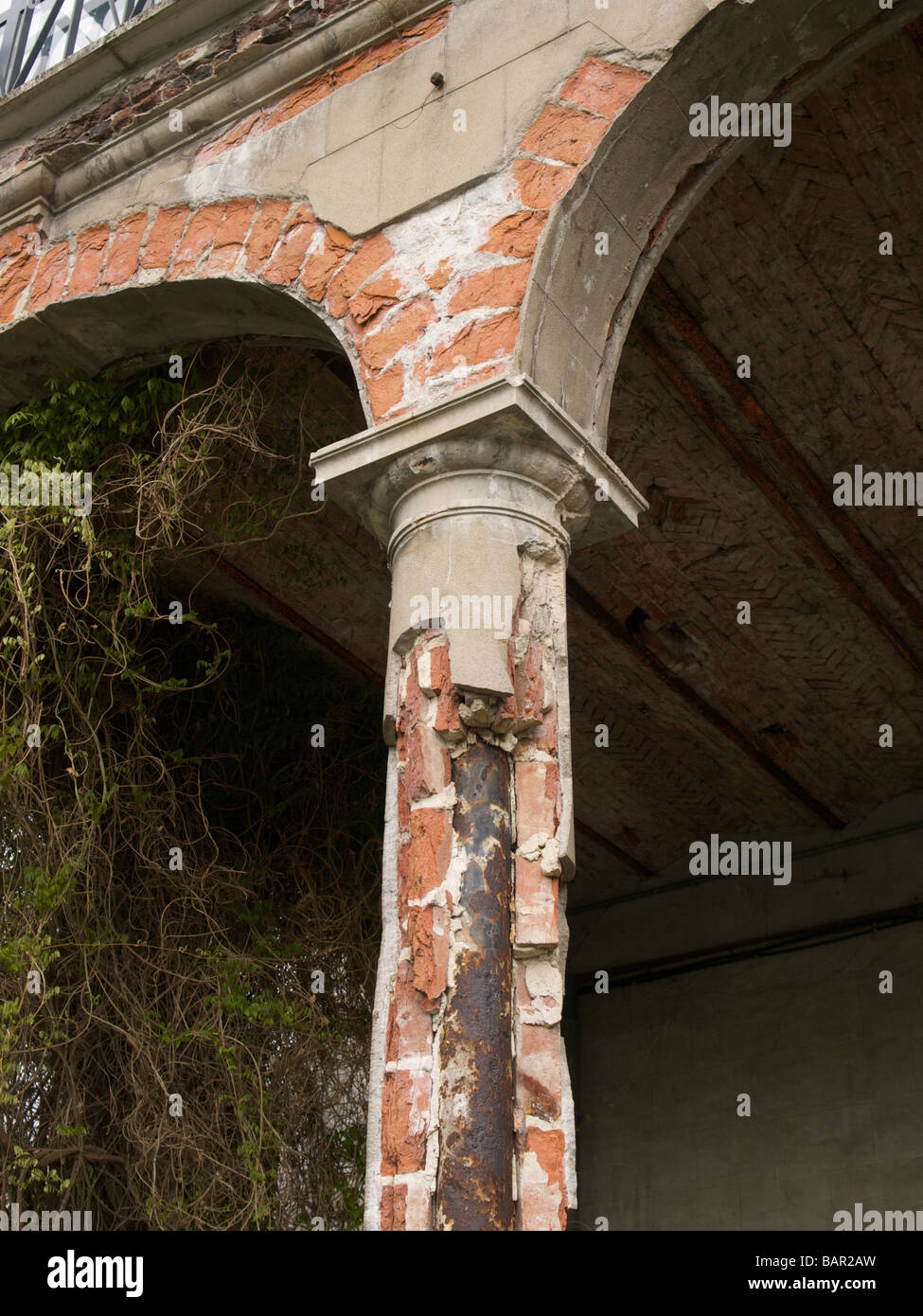 Delapidated column showing its inner construction with iron pole bricks and plaster Oteppe chateau Belgium Stock Photo