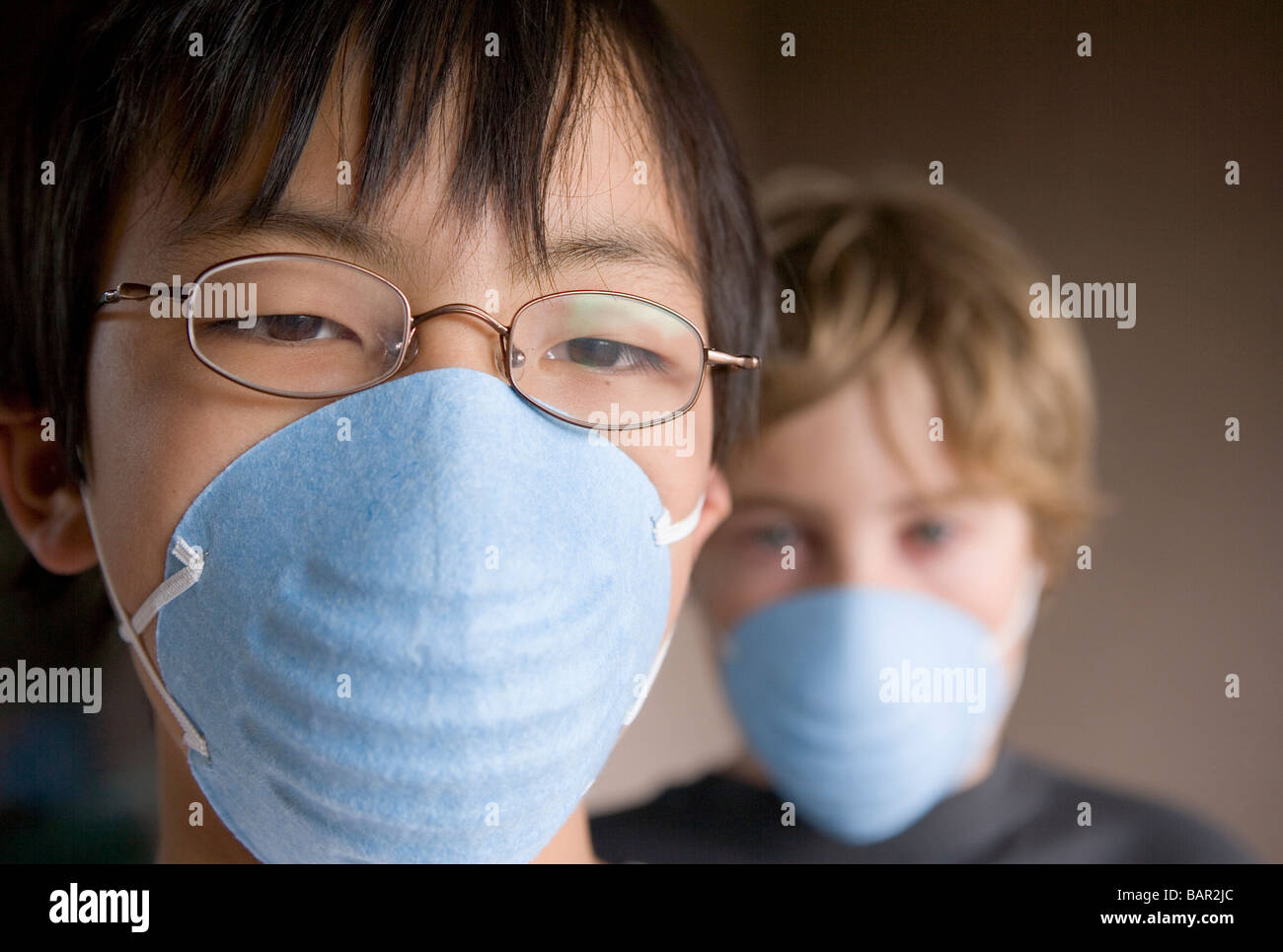 closeup of two children, ages 12 and 10 wearing masks Stock Photo Alamy