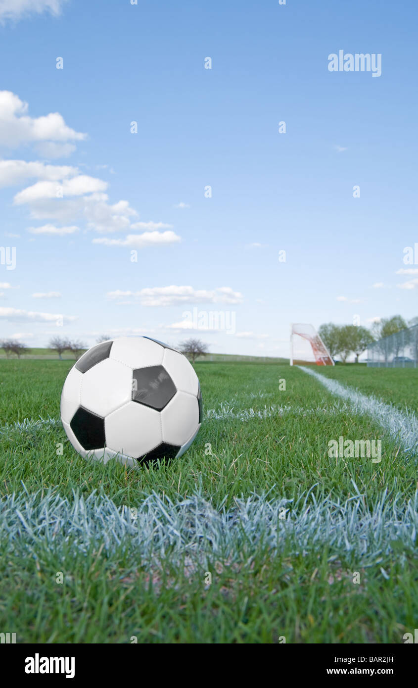 Soccer ball in corner pitch area against blue sky Stock Photo Alamy