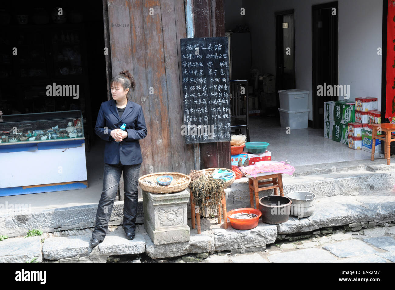 Chinese street vendor, in the village of SanHe, Anhui province, China. Selling the locally caught fish. Stock Photo