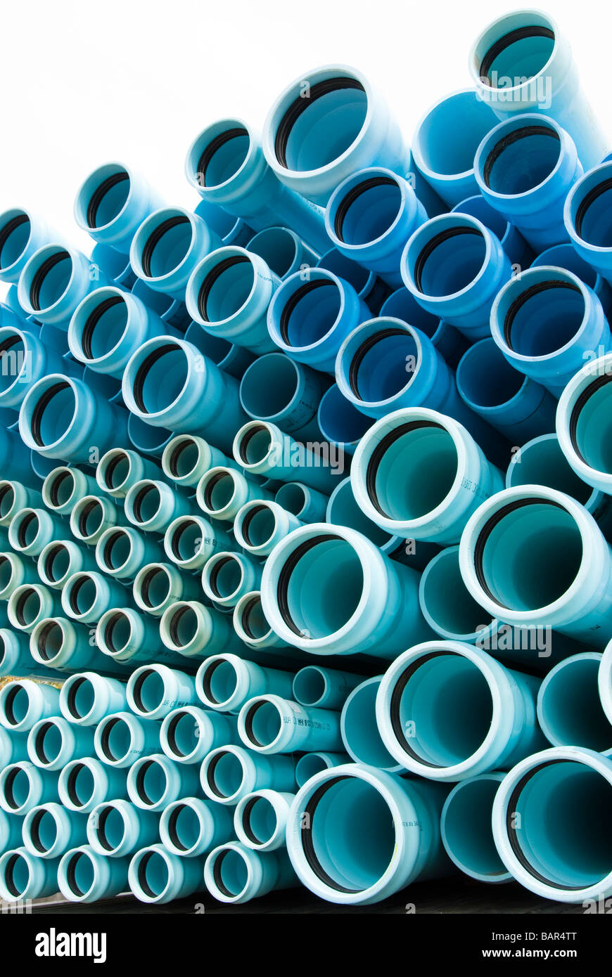 pvc water and sewer pipe being transported to a construction site Stock Photo