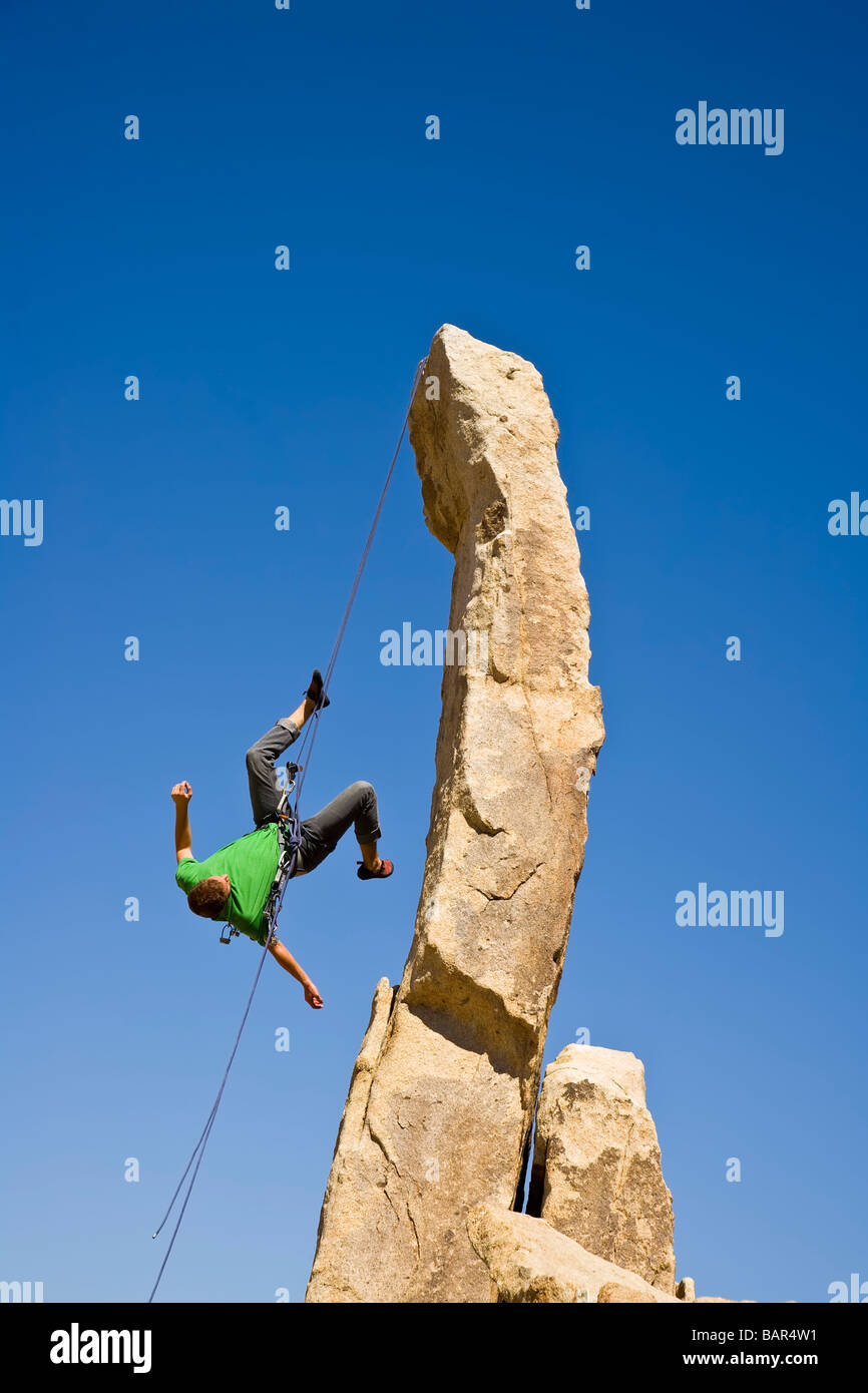 A rock climber rappelling from a rock spire Stock Photo Alamy