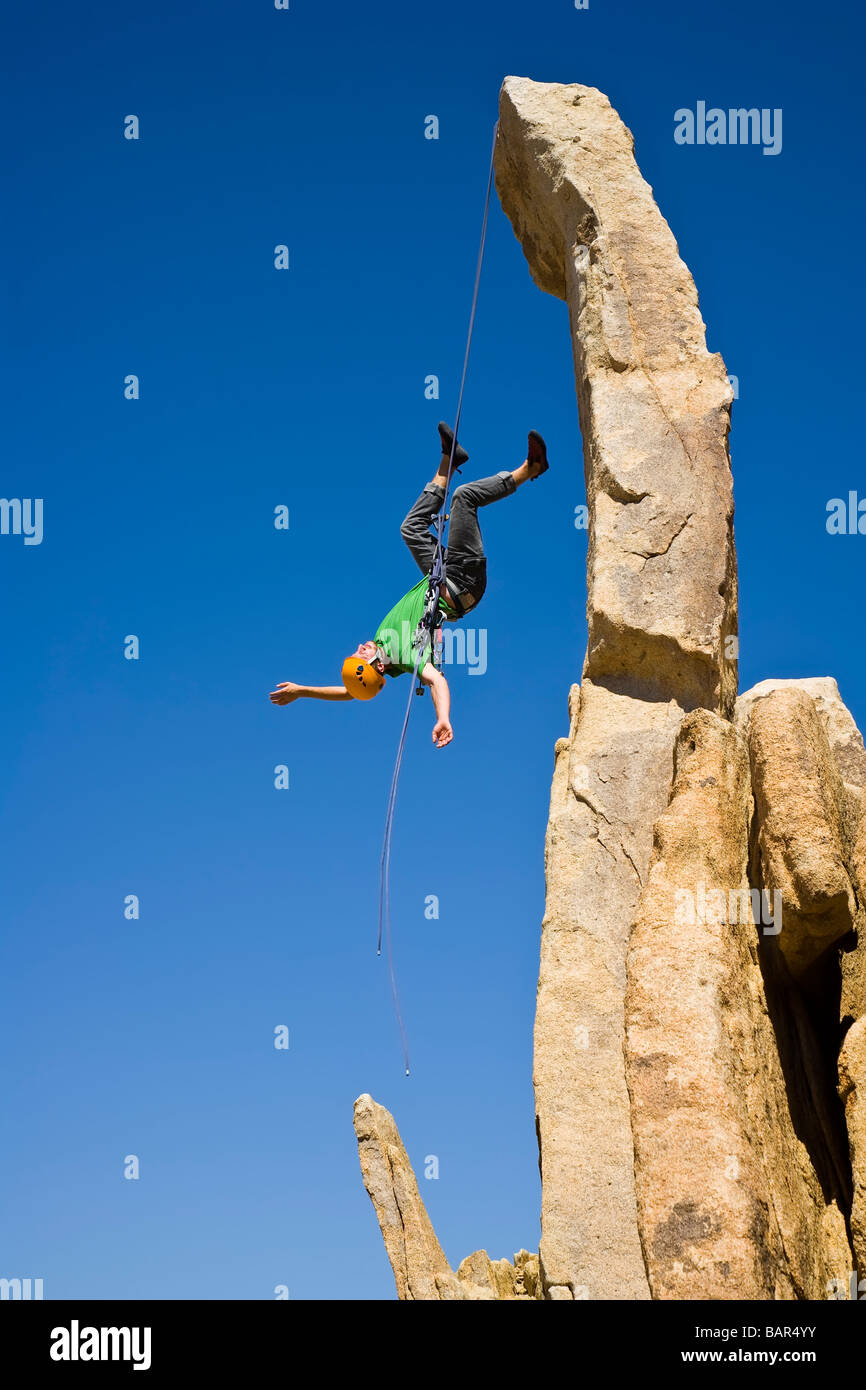 A rock climber rappelling from a rock spire Stock Photo Alamy
