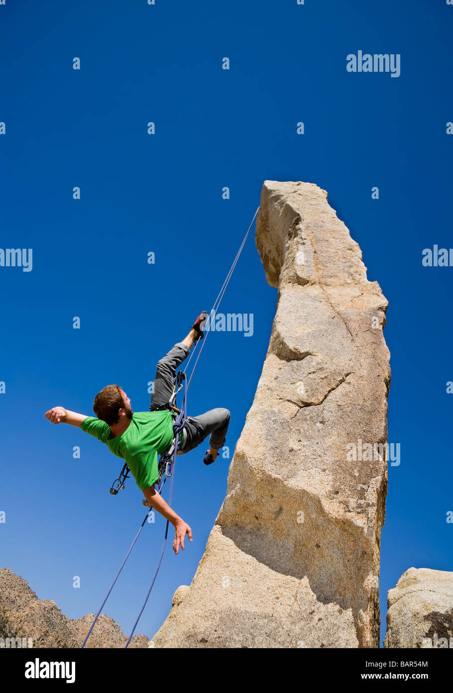 A rock climber rappelling from a rock spire Stock Photo Alamy
