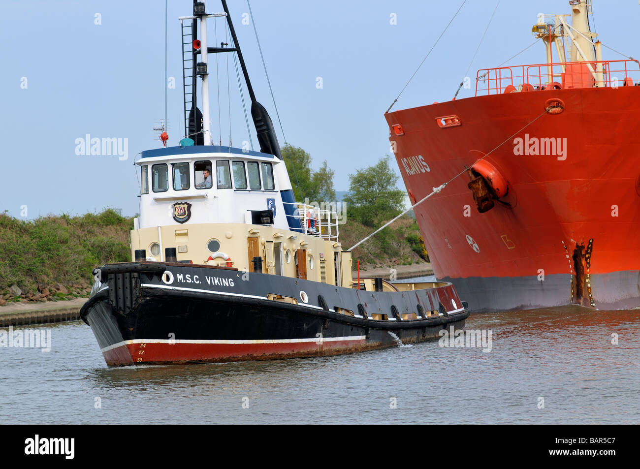 Tugboat MSC Viking guiding the bulk chemical oil products tanker Acavus Stock Photo