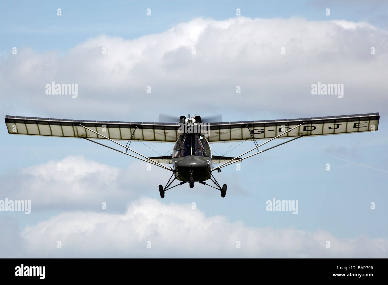A microlight aircraft flying at Popham airfield in Hampshire in England ...