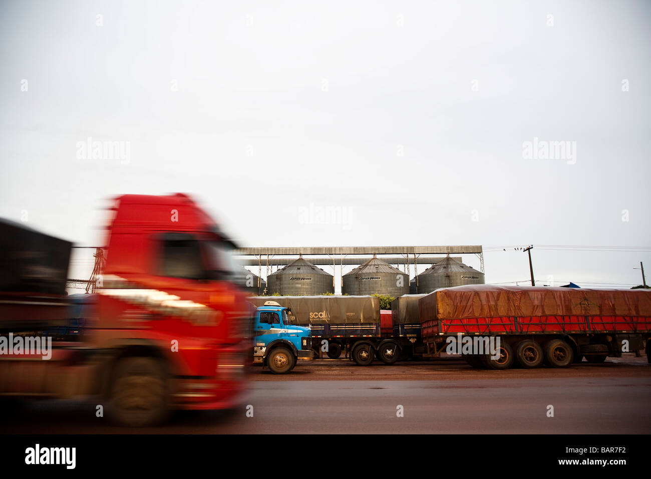 Transportation of grains trucks and silos at BR 163 road at Mato Grosso State Brazil Stock Photo