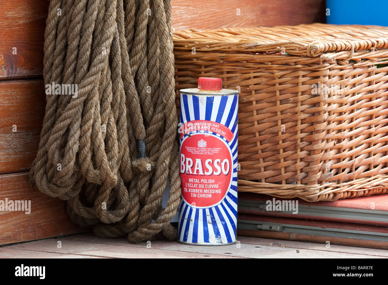 Tin of Brasso between rope and whicker basket on back of lorry during vintage commercial vehicle rally, Brighton. Stock Photo