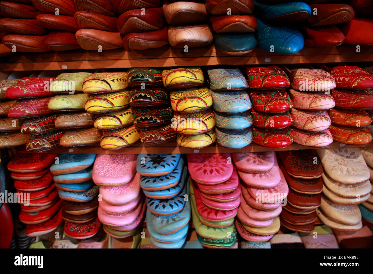 Traditional Moroccan leather babouches/sandals/slippers for sale in a tannery shop deep in the depths of Fes/Fez medina, Morocco Stock Photo