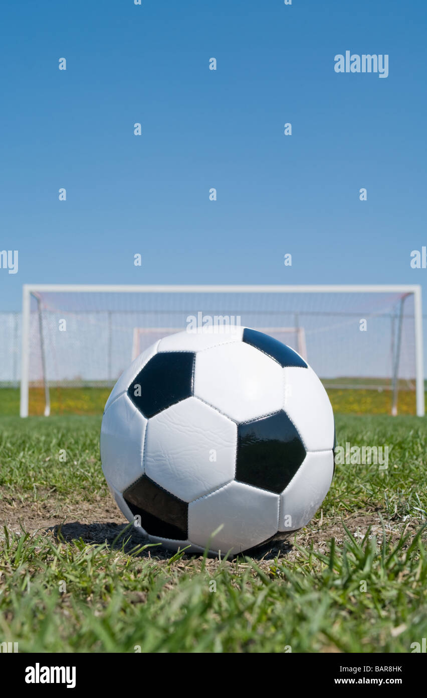 Soccer Ball On The Pitch Field With Goal In Background Stock Photo Alamy
