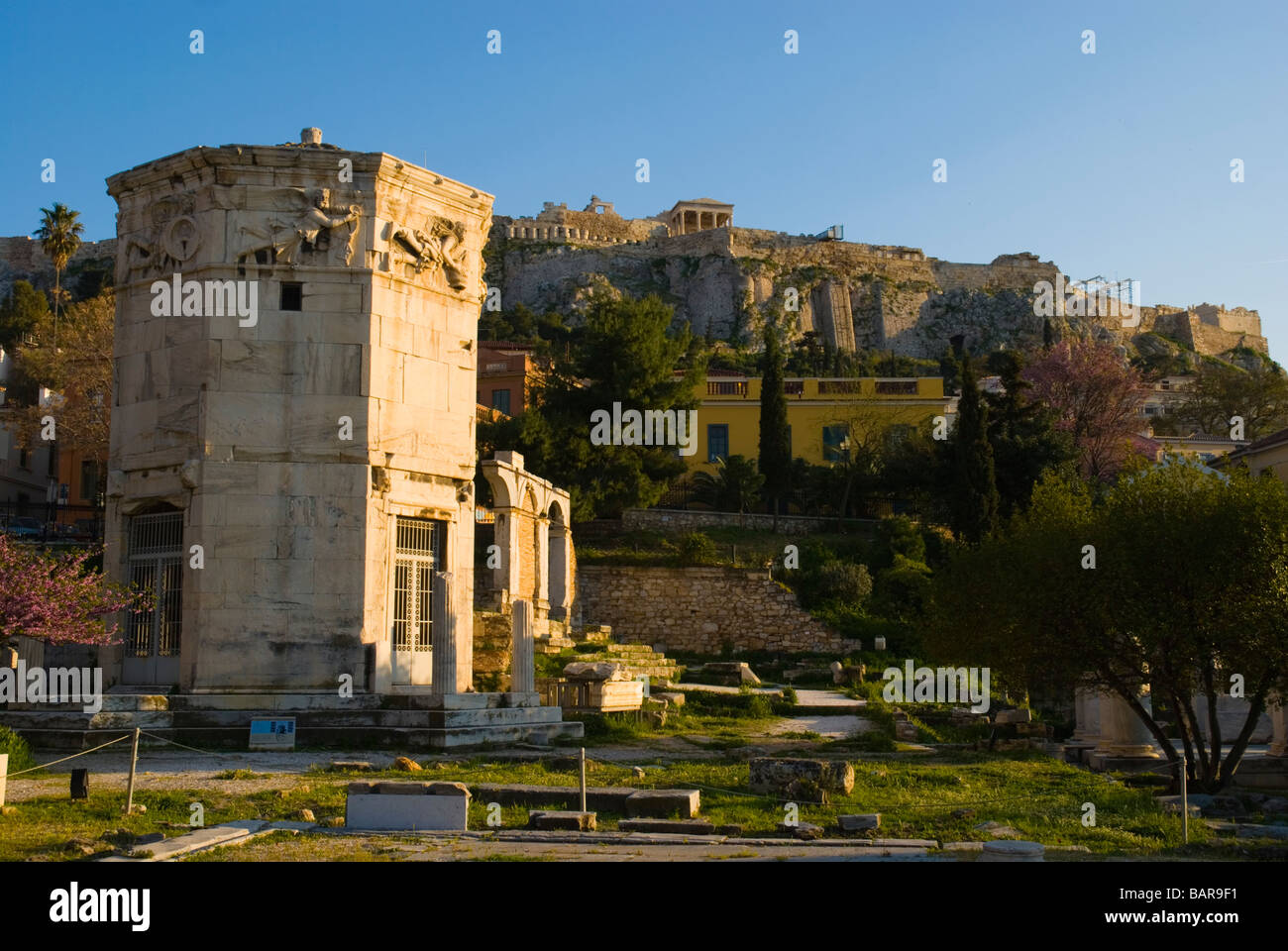 Tower of the Winds at Roman Agora with Acropolis in teh background in Plaka district of Athens Greece Europe Stock Photo
