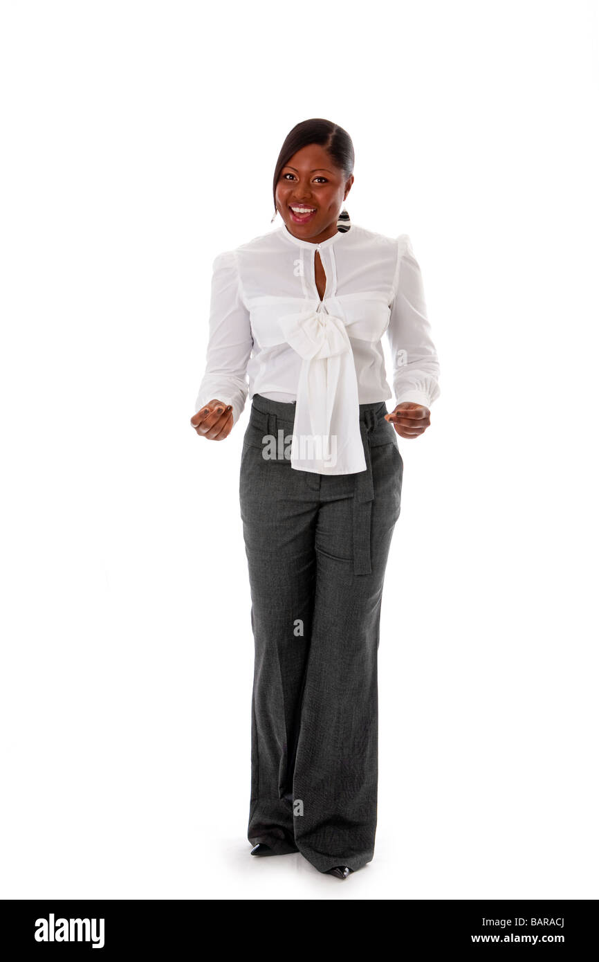 Beautiful African American business woman dressed in a white shirt and gray pants standing snapping fingers isolated Stock Photo