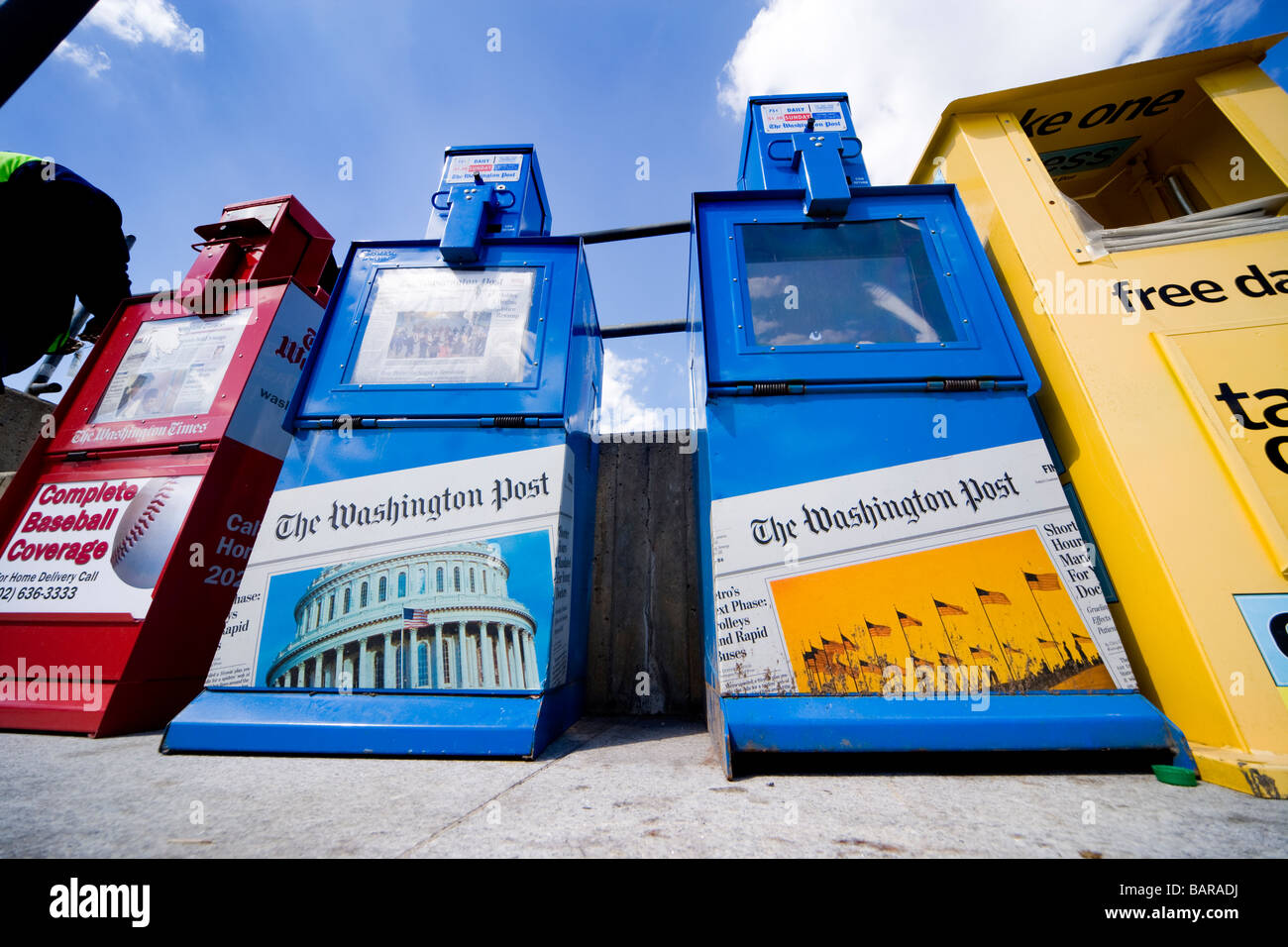 Newspaper vending machines on the sidewalk selling The Washington Post