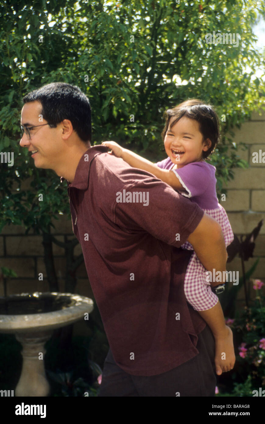 Japanese-American father daughter piggy-back ride play share fun smile  laugh joy enjoy sun outdoor outside exercise Stock Photo - Alamy