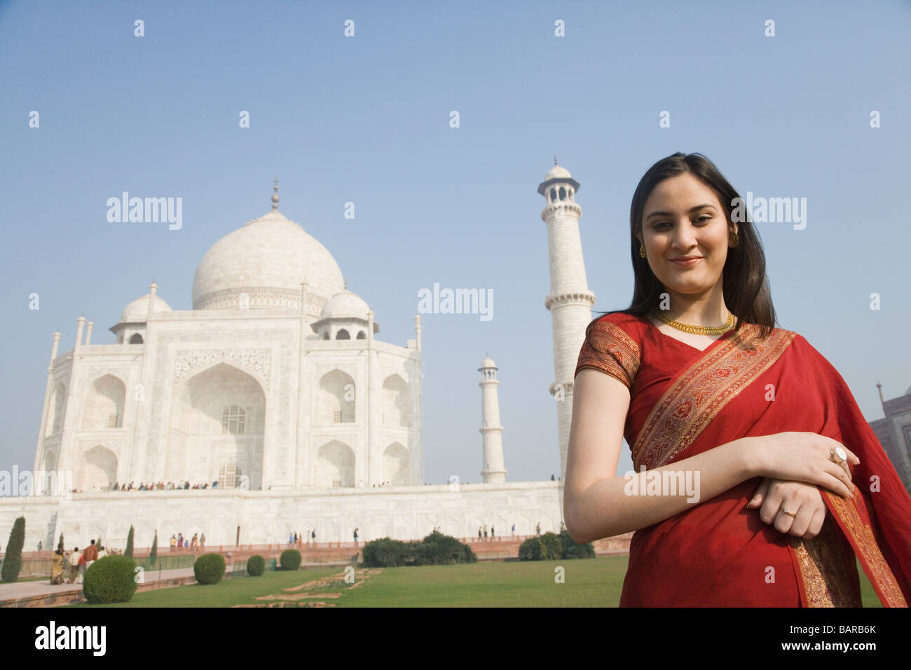 Woman standing in front of a mausoleum, Taj Mahal, Agra, Uttar Pradesh ...