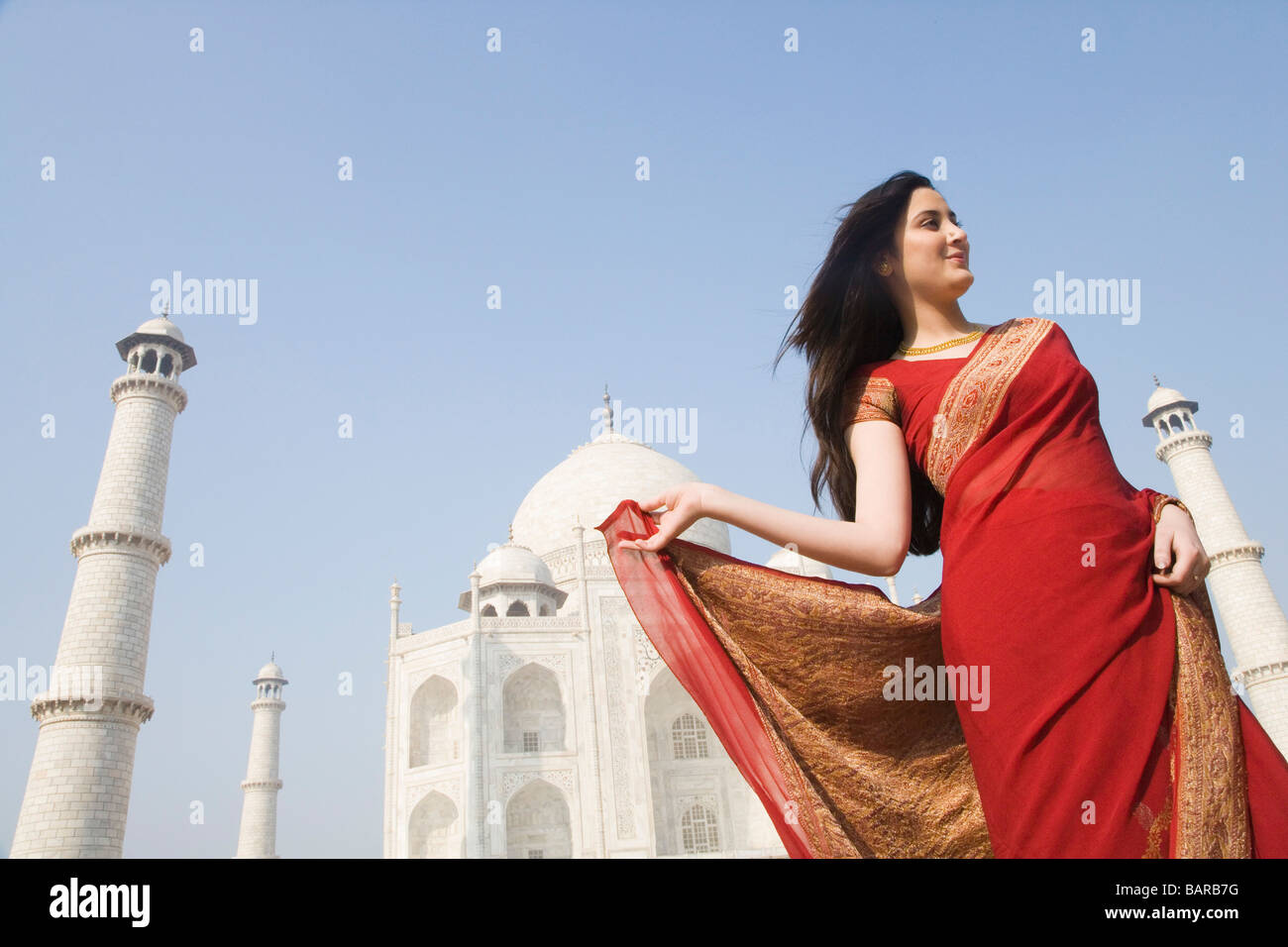 Woman standing in front of a mausoleum, Taj Mahal, Agra, Uttar Pradesh ...
