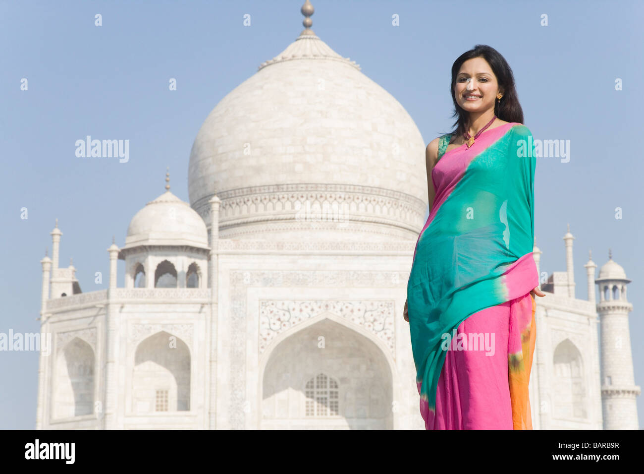 Woman standing in front of a mausoleum, Taj Mahal, Agra, Uttar Pradesh, India Stock Photo