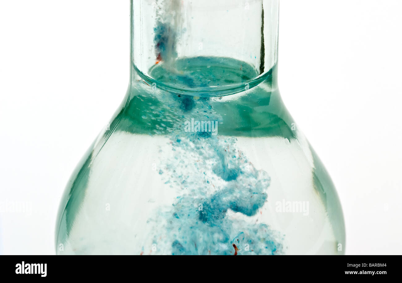 Glass bottle with powdered drink mix pouring in from the Stock Photo