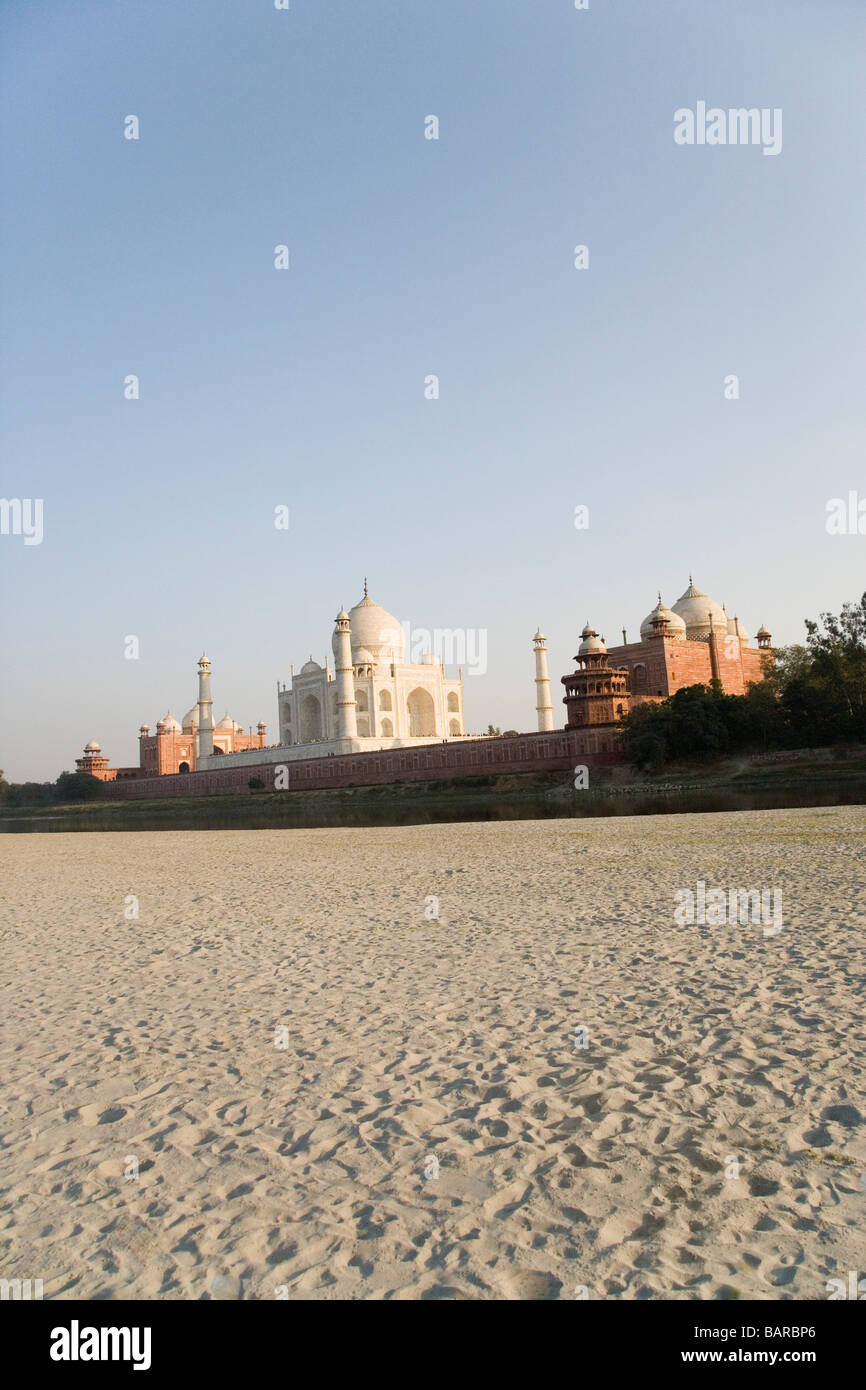 Sand on a riverside with a mausoleum in the background, Taj Mahal, Agra ...
