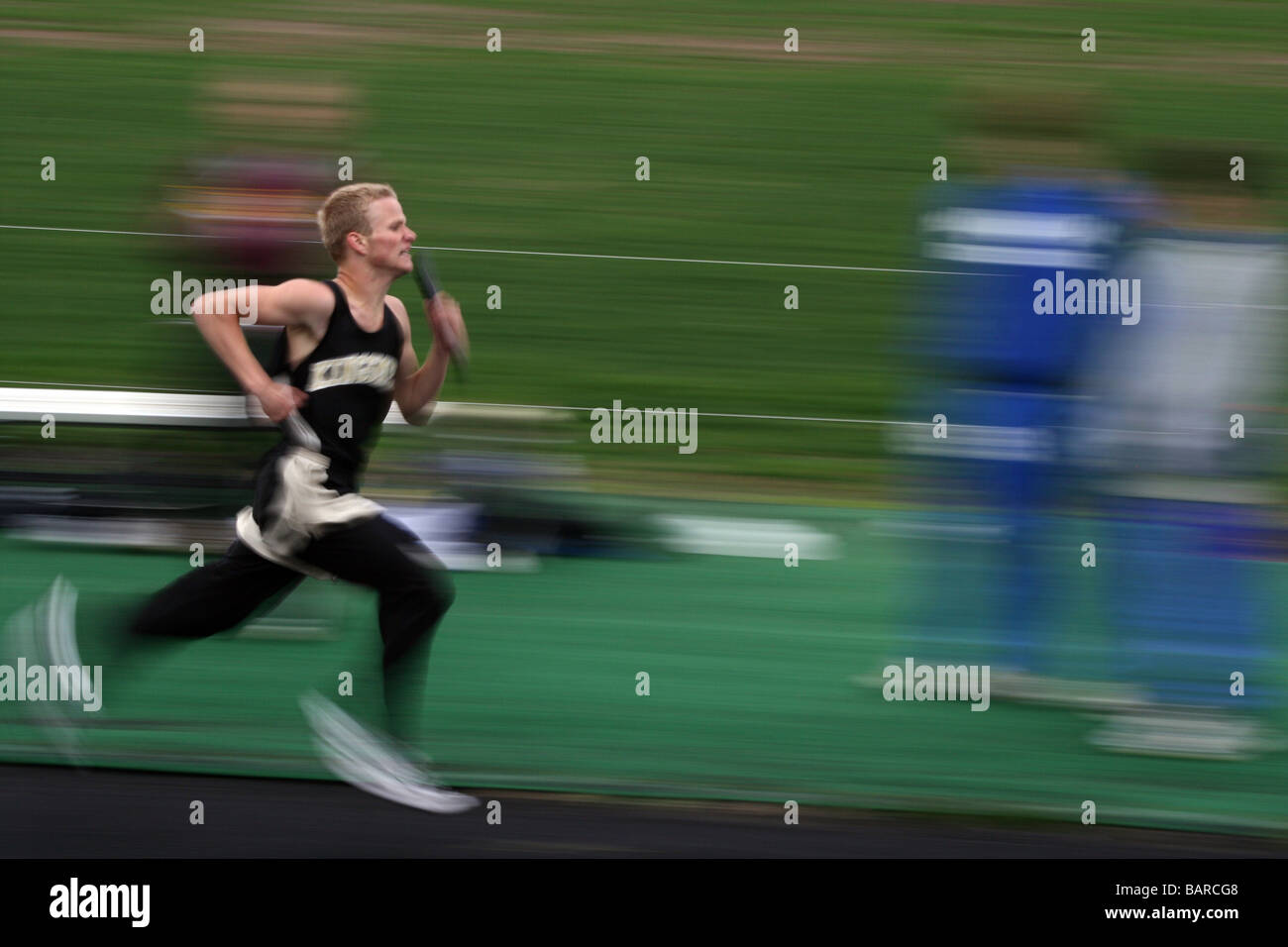 Winning the 1600 meter relay in a high school track meet. Stock Photo