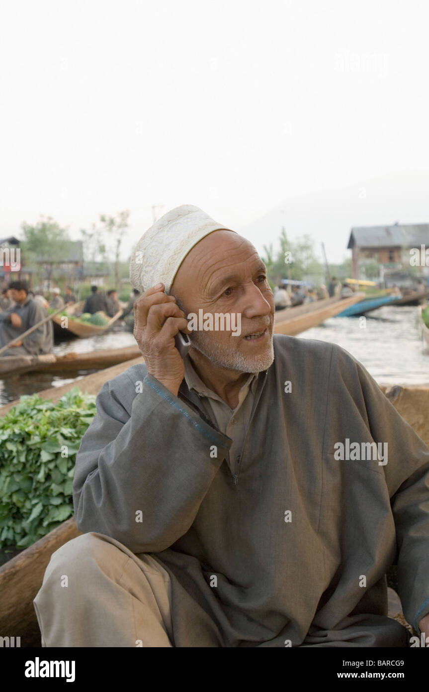Man talking on a mobile phone, Dal Lake, Srinagar, Jammu And Kashmir, India Stock Photo