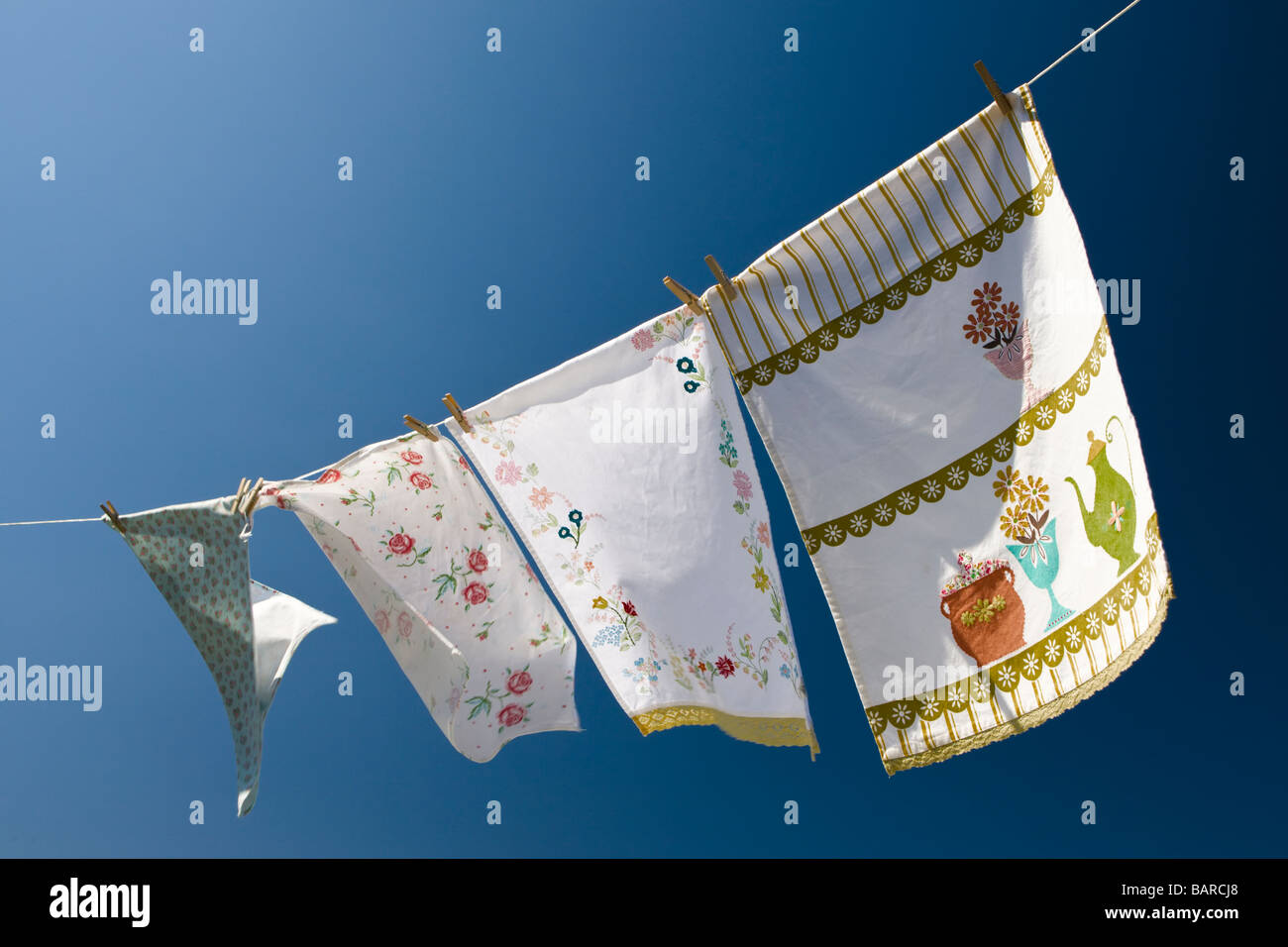 Environmentally friendly: Colorful washing, drying in the wind under a deep blue sky. Stock Photo
