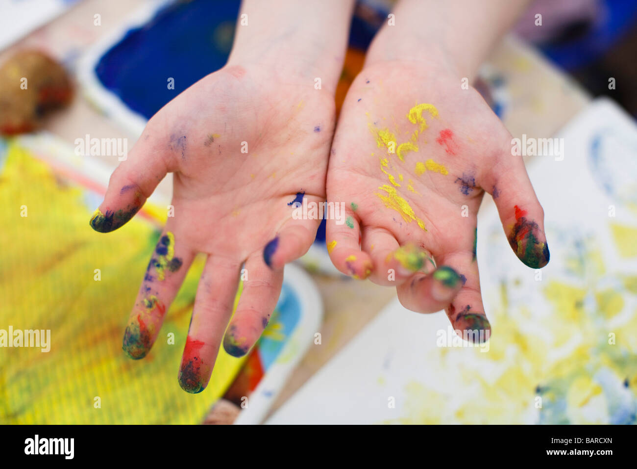 Close up of a childs hands with acrylic paint on Stock Photo
