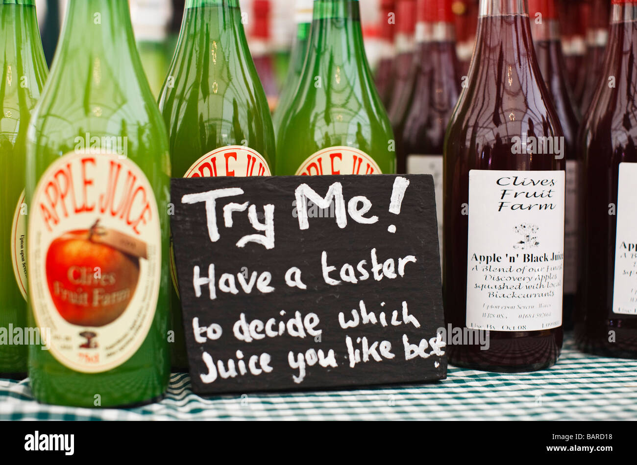 Apple juice on sale on a farmers market stall, UK Stock Photo