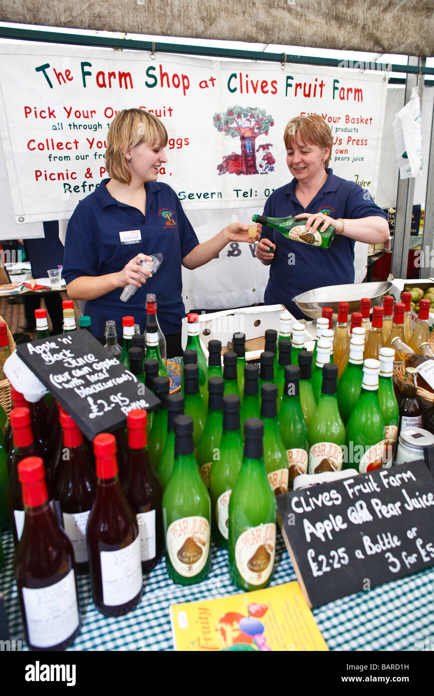 Bottles of apple juice on sale at a farmers market, UK Stock Photo