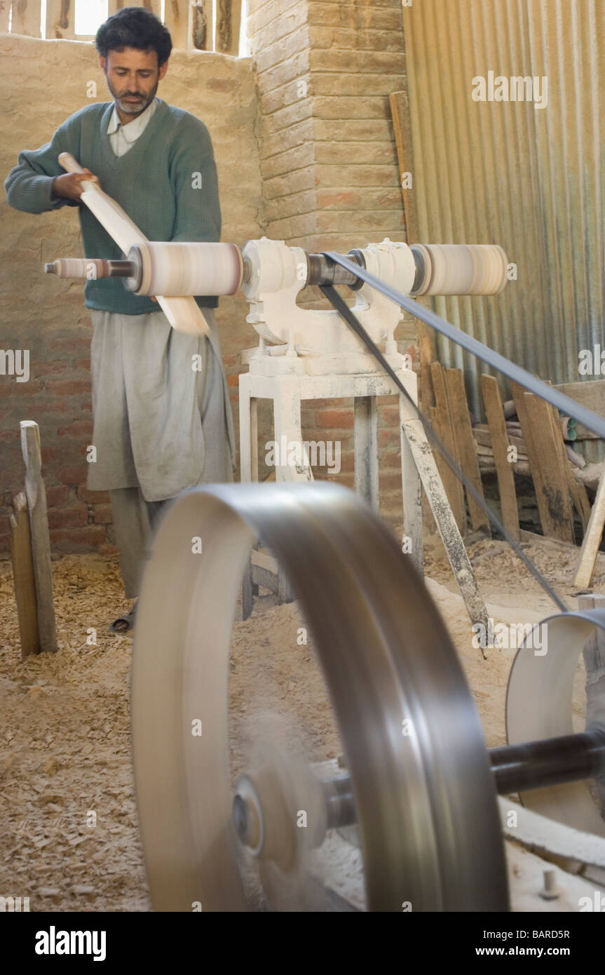 Carpenter making bat in a bat factory, Jammu and Kashmir, India Stock Photo