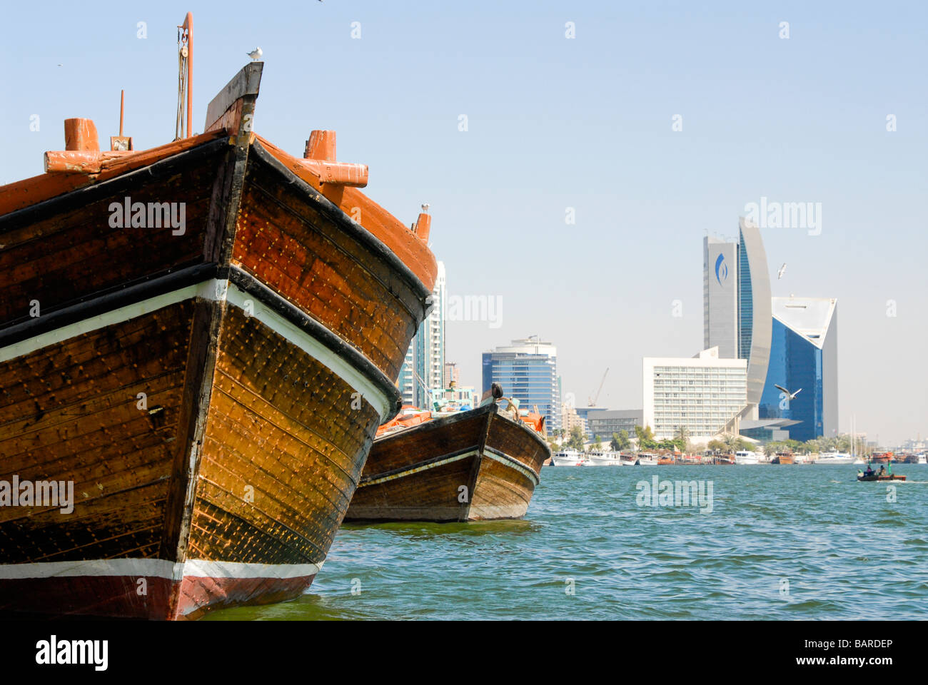 Dhows in front of hotel skyline, The Creek, Dubai, UAE Stock Photo