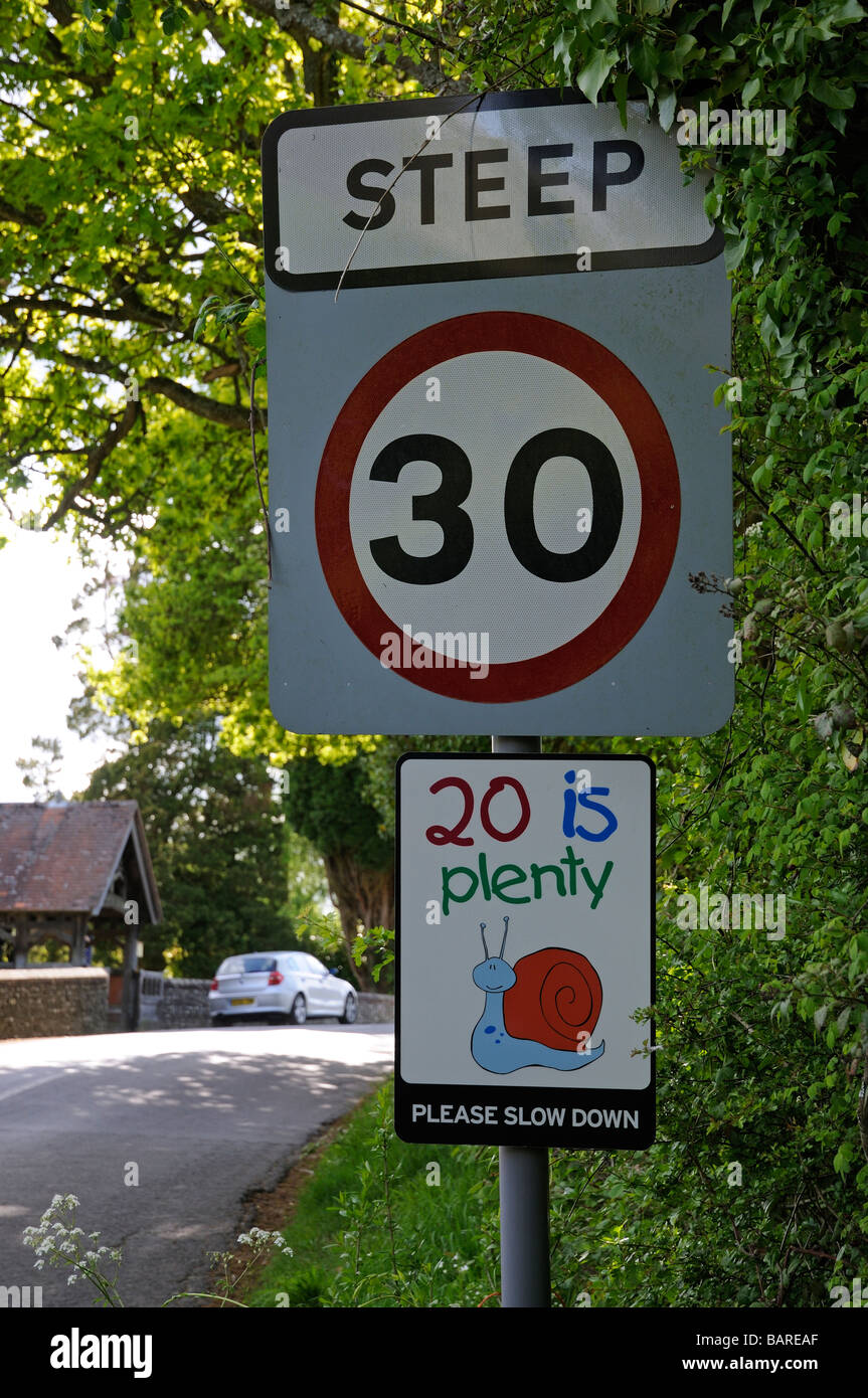 20 is plenty speed limit road signs 30 mph english village England UK Stock Photo