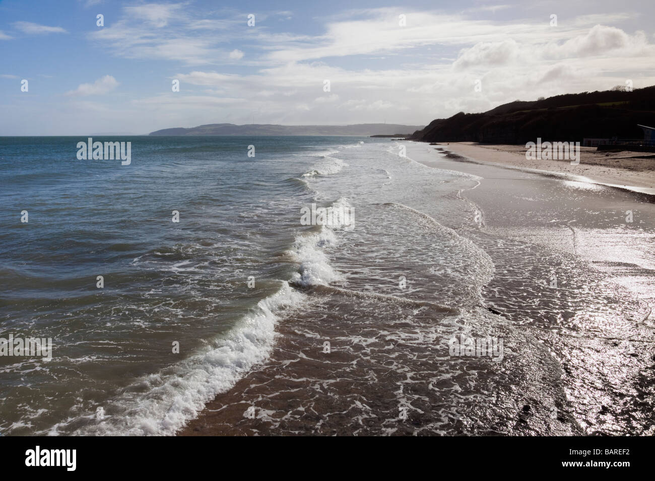 Benllech Isle of Anglesey North Wales UK Europe View along waves on shoreline of empty beach