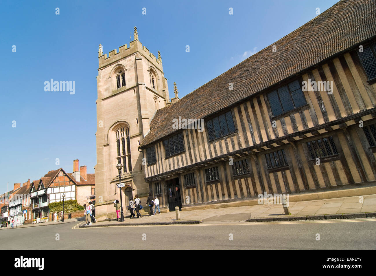 Horizontal wide angle of the old Tudor Almshouses Guild Chapel and Nash's House on Church Street on a bright sunny day Stock Photo
