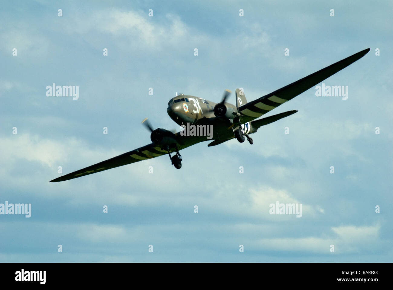 A DC3 Dakota Transport Plane on a display flight at an airshow with D Day Livery Stock Photo