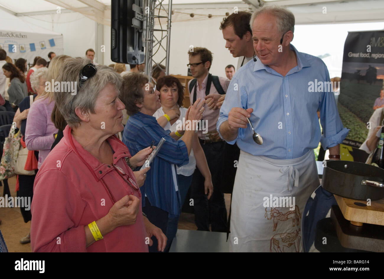 Matthew Fort giving food cooking demonstration audience member. Tom Parker Bowles (behind) Aldeburgh Food Fair at Snape Maltings Suffolk 2009 2000s UK Stock Photo