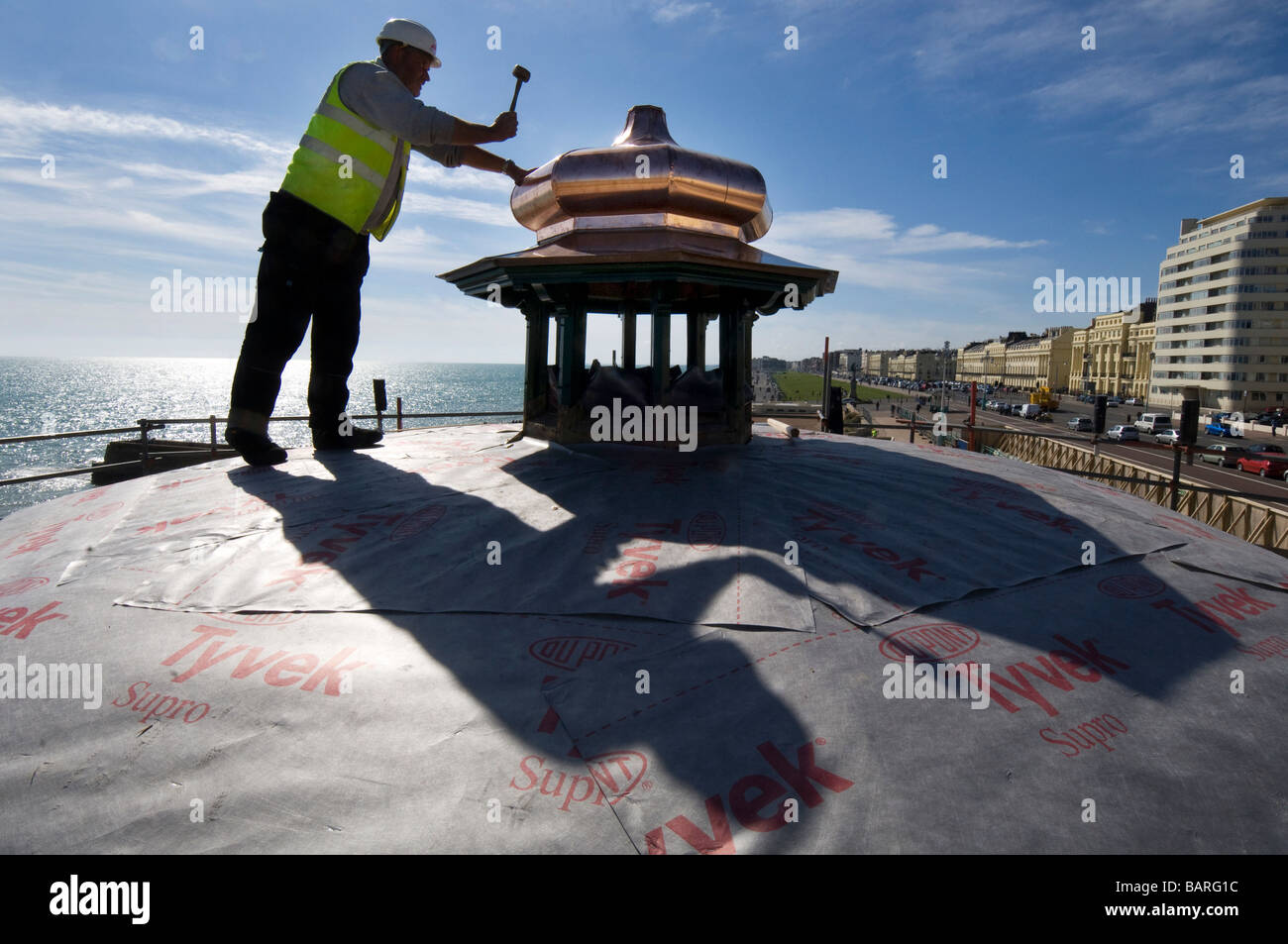 A coppersmith restores the cupola of Brighton Bandstand on the seafront Stock Photo