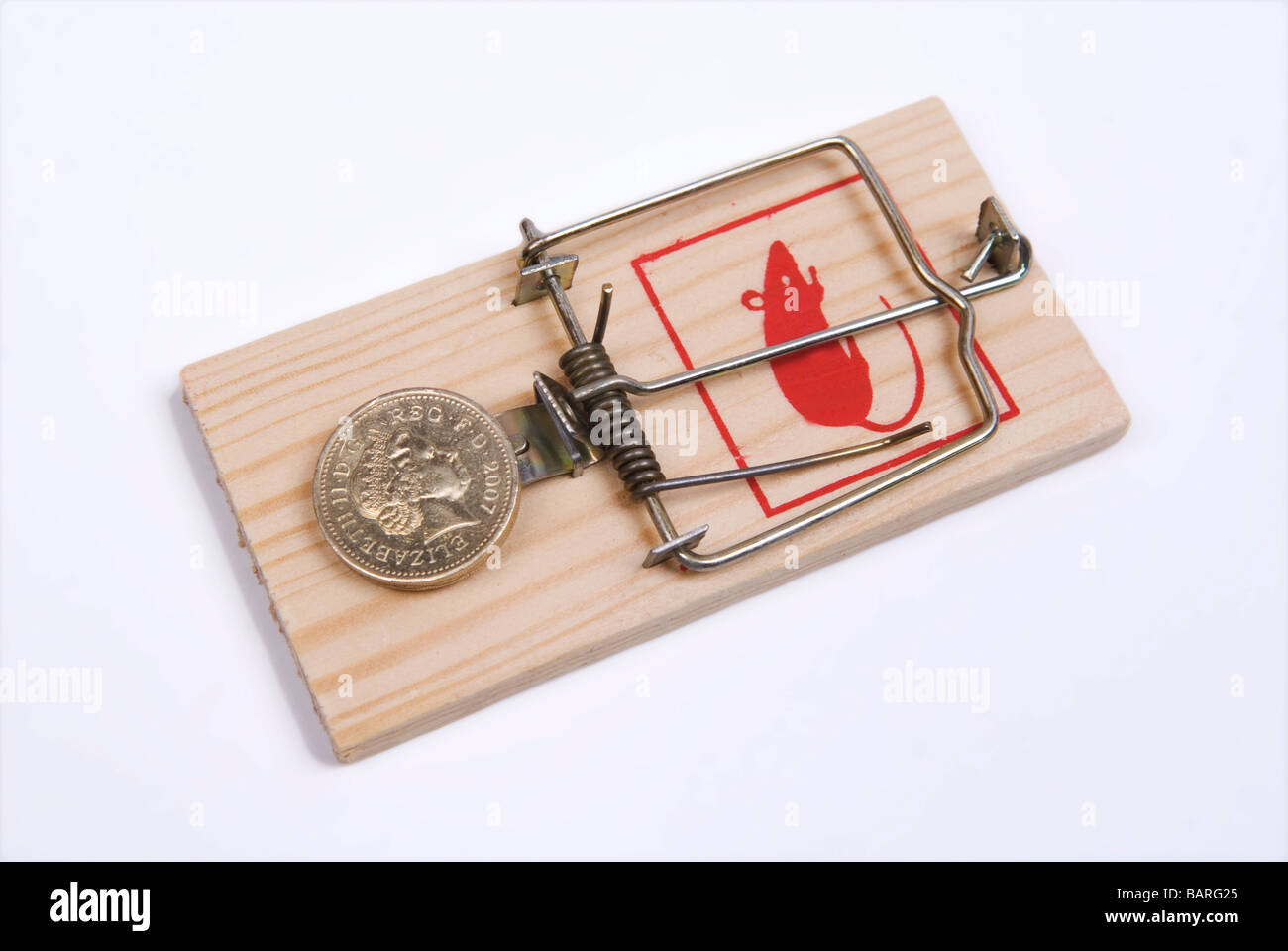 One pound British coin on a mouse trap against a white background Stock Photo
