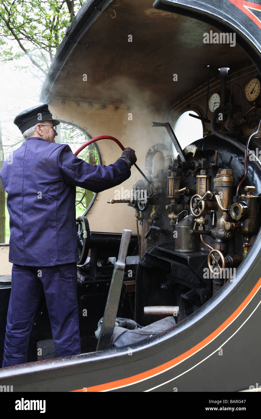 A driver on the North Norfolk Railway cleaning the cab interior of a Lancashire and Yorkshire Railway steam locomotive, England, UK Stock Photo