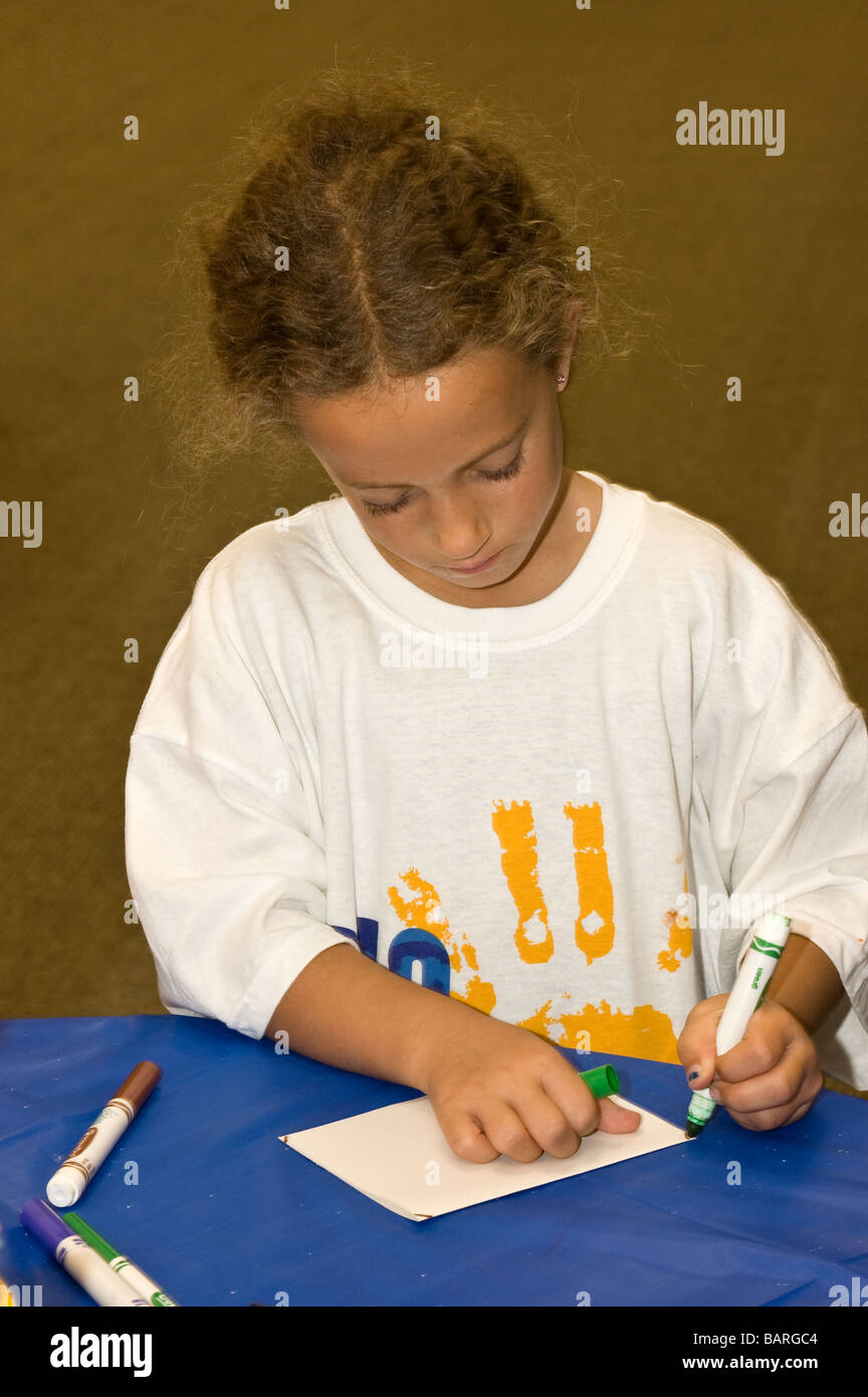 A young Jewish girl makes a card to be donated; University Synagogue