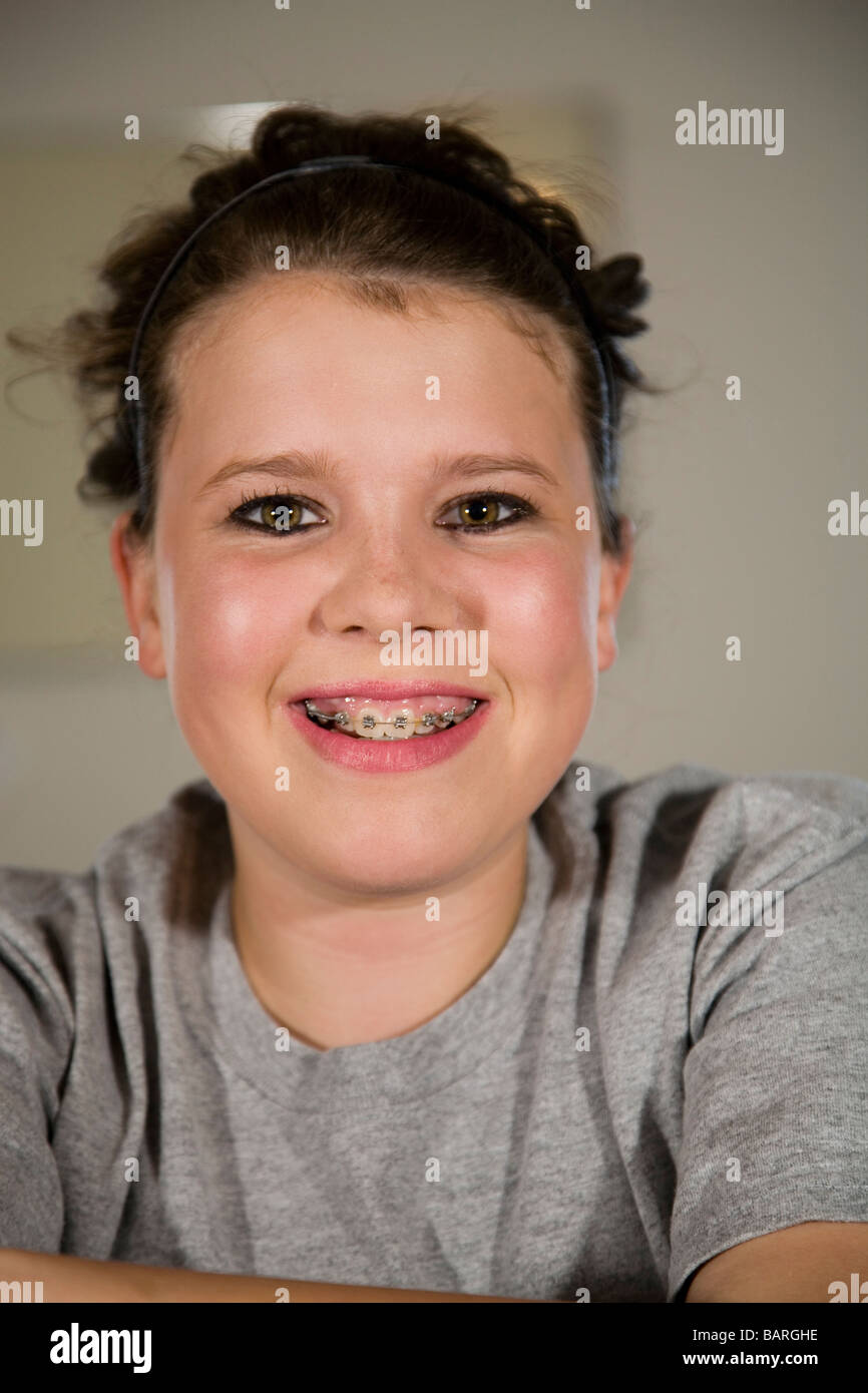 A pretty teenage girl with braces wearing heavy eye makeup Stock Photo
