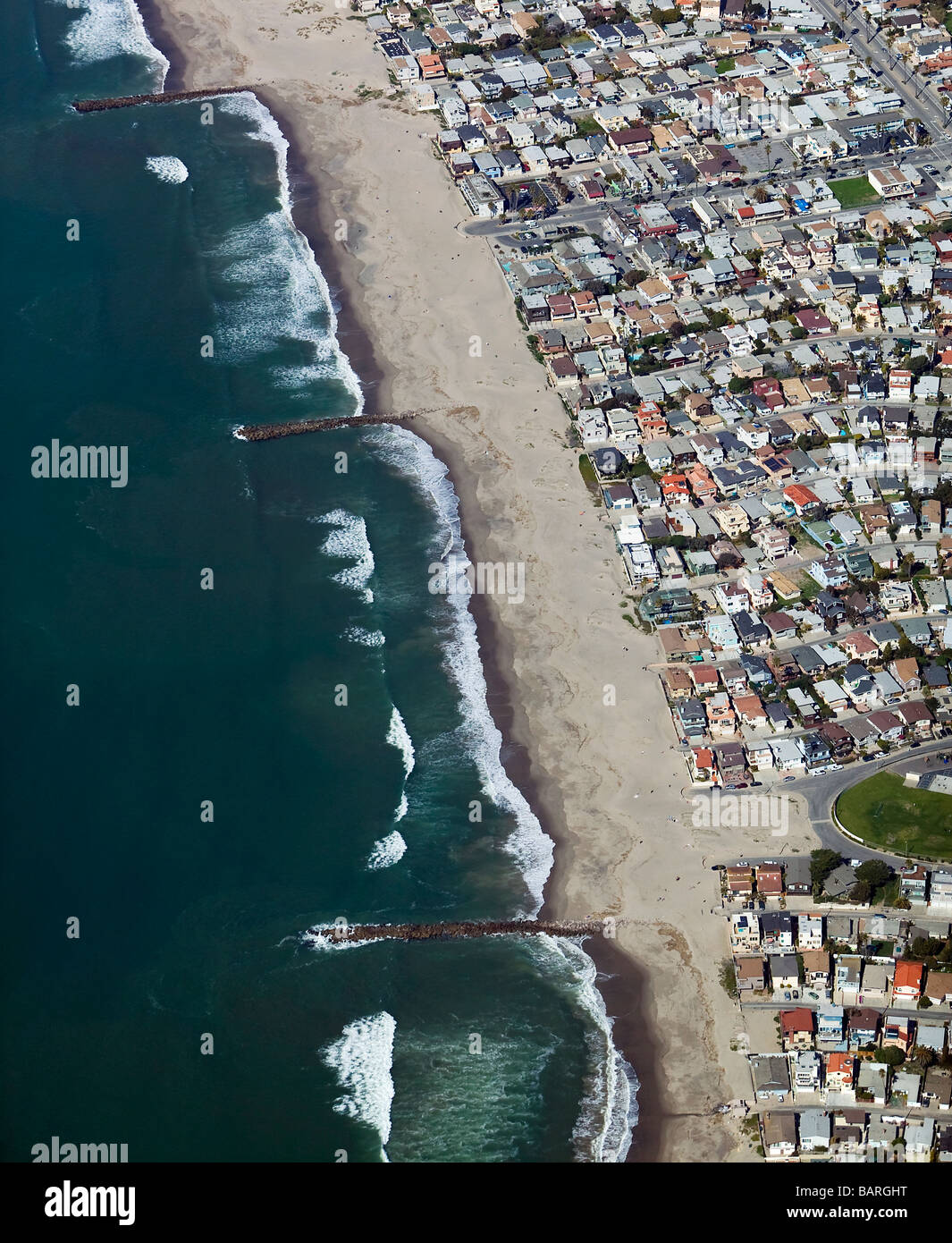 aerial view above breakwaters controlling coastal erosion residential development southern California Stock Photo
