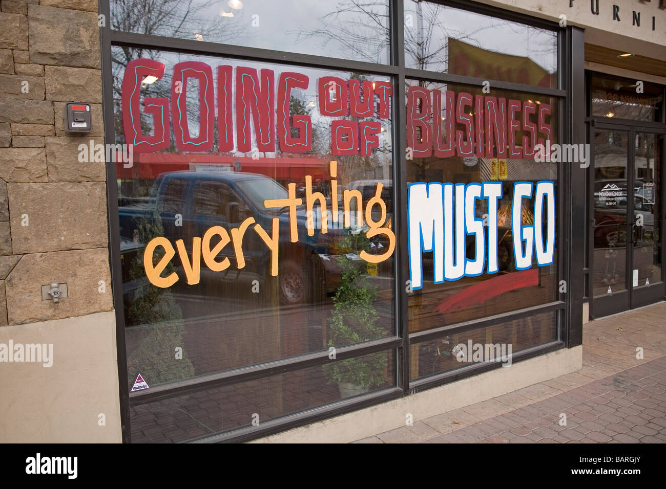 A going out of business sign on a storefront. Stock Photo
