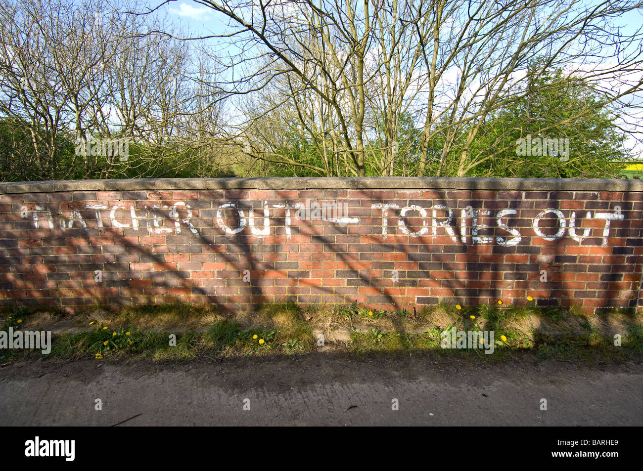 Thatcher out Tories out, a political message painted onto a brick wall Stock Photo