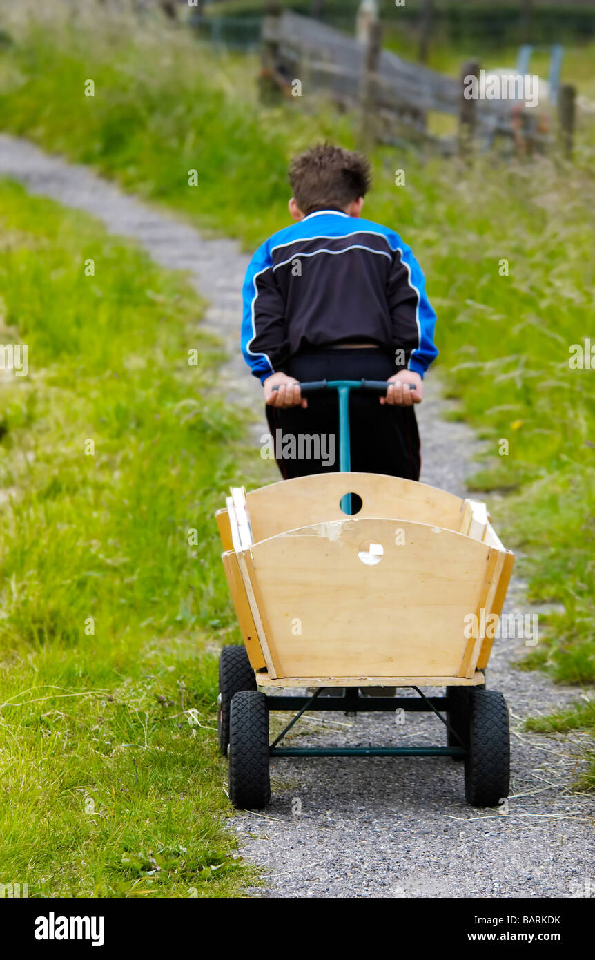 A boy pulling a wagon Stock Photo