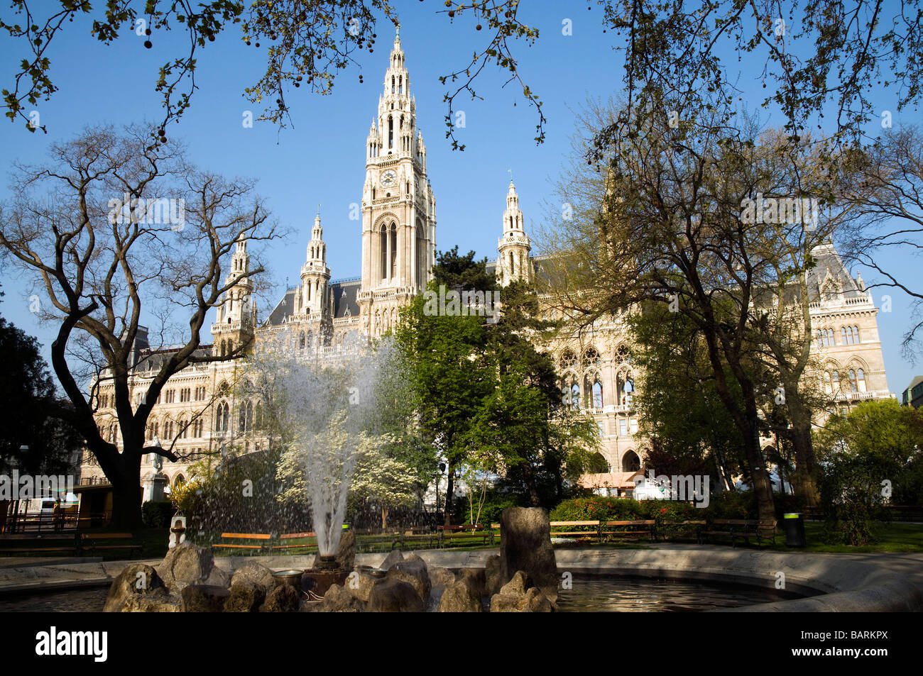 early morning view of the Viennese Rathaus from the park with fountain in the forefront Stock Photo