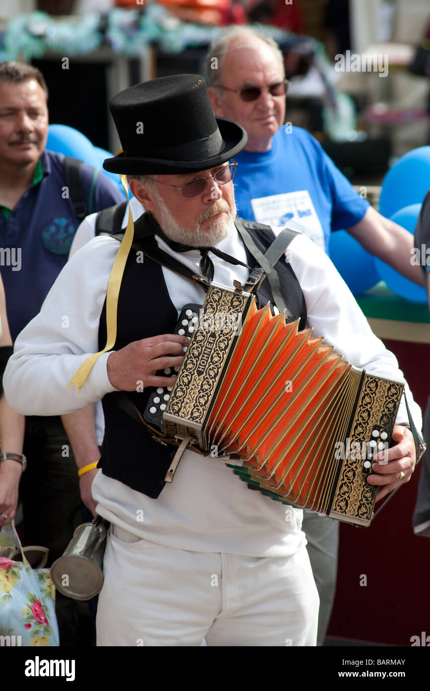 Squeeze box player in traditional English costume. Canal Cavalcade Festival, Little Venice, London, England. Stock Photo